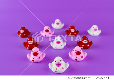 Adorable Rubber Duck Collection on Purple Background: A Fun Display of Playful Ducklings in Various Colors and Designs Bringing Joy and Whimsy to Any Setting 123075310