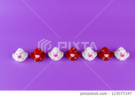 Colorful Rubber Duck Collection on Purple Background with Happy Expressions - A Fun Display of Cute and Quirky Bath Toys Perfect for Children and Collectors Alike 123075347