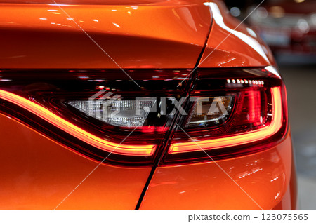 Tail light of nice and new orange sport suv car in modern garage. Tail light of nice and new orange sport suv car in modern garage. 123075565