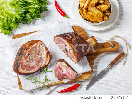 Smoked pork knuckle, ham hock on cutting board Smoked pork knuckle, ham hock on cutting board 123075995