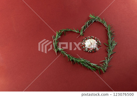 Discover the Elegant Heart-Shaped Decoration Made from Fresh Rosemary and Colorful Spices, Perfect for Culinary and Romantic Aesthetics on a Rich Red Backdrop Discover the Elegant Heart-Shaped Decoration Made from Fresh Rosemary and Colorful Spices, Perfect for Culinary and Romantic Aesthetics on a Rich Red Backdrop 123076500
