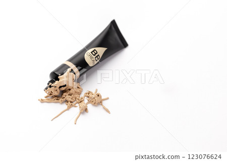 A Beautifully Spilled BB Cream Tube on a White Surface with the Cream Oozing Out, Highlighting the Product's Texture and Color for Makeup Enthusiasts and Fashion Lovers. 123076624