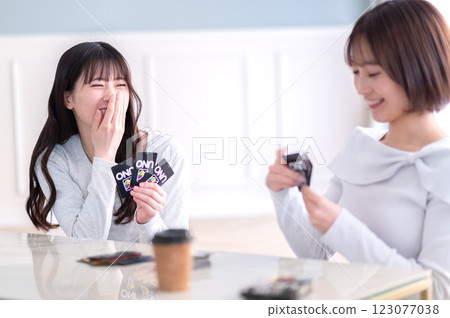 Two young women playing a card game 123077038