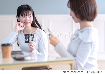 Two young women playing a card game 123077044