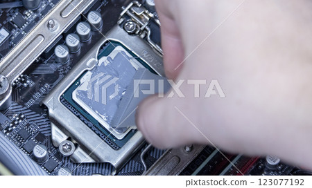 girl programmer apply thermal paste on the computer processor, macro photography girl programmer apply thermal paste on the computer processor, macro photography 123077192