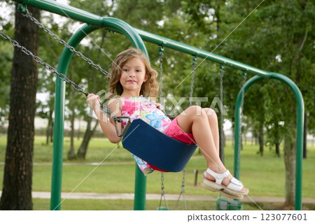 Beautiful little girl playing with swing 123077601