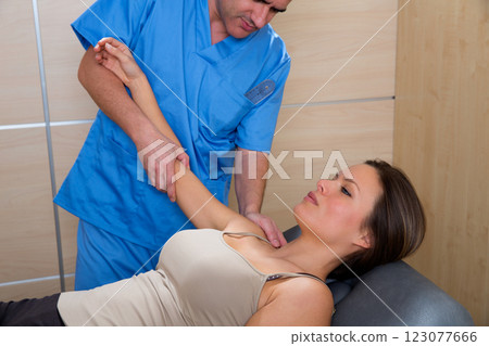 Shoulder physiotherapy doctor therapist and woman Shoulder physiotherapy doctor therapist and woman 123077666