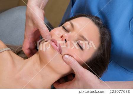 Facial tuina massge therapy on beutiful woman face 123077688