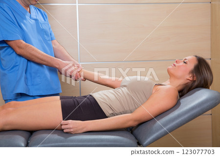 fascial therapy doctor pulling patient woman arm fascial therapy doctor pulling patient woman arm 123077703