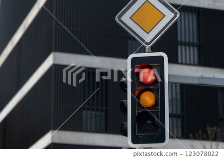 Red and yellow traffic lights on urban city background 123078022