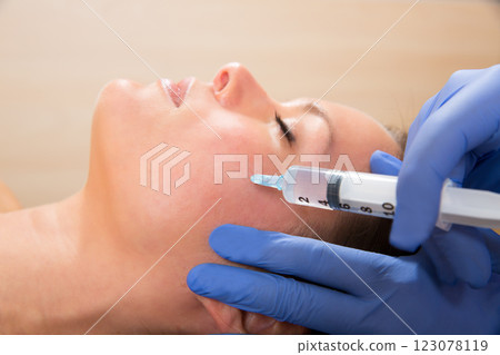 Anti aging facial mesotherapy syringe on woman face Anti aging facial mesotherapy syringe on woman face 123078119