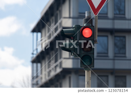 Red traffic light on street building background 123078154