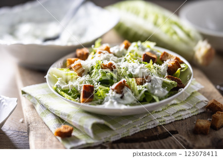 Healthy Caesar salad made with Romaine lettuce, croutons, tzatziki dressing and parmesan cheese. 123078411