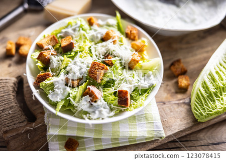 Healthy Caesar salad made with Romaine lettuce, croutons, tzatziki dressing and parmesan cheese. 123078415