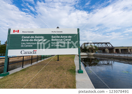 Sainte-Anne-de-Bellevue, Quebec, Canada - August 27 2021 : Sainte-Anne-de-Bellevue Canal National Historic Site of Canada. Railroad Galipeault Bridge in the background. 123078491