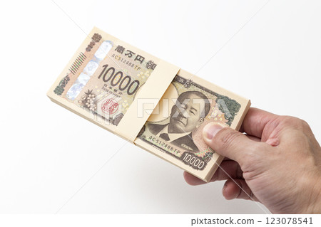 Hand holding a stack of 1 million yen bills 123078541