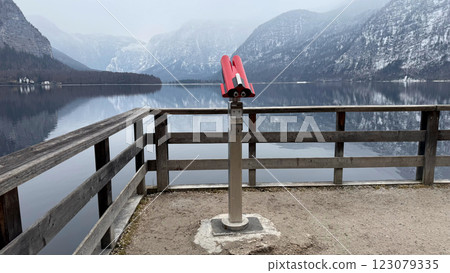 Binocular Viewer Overlooking Scenic Winter Lake Hallstatt in Austria and Snow-Covered Alpine Mountain Landscape 123079335