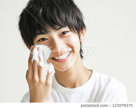 AI-generated image of a young Japanese boy applying foam to his cheek with his finger 123079375