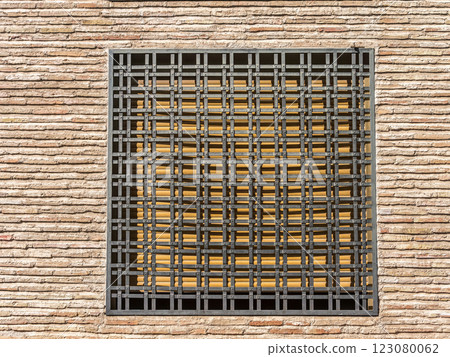 Brick Wall with ornamental Metal Security Bars On a Window 123080062