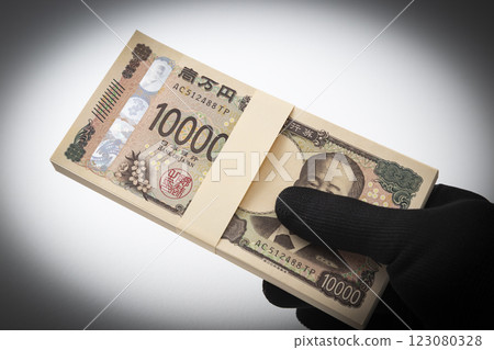 Hand holding a stack of 1 million yen bills 123080328