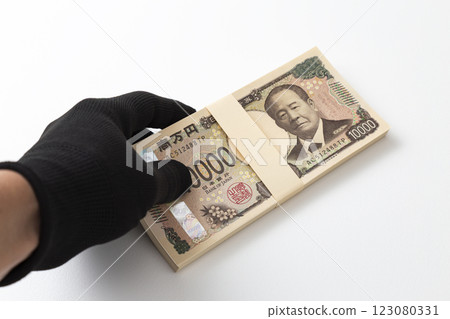 Hand holding a stack of 1 million yen bills Hand holding a stack of 1 million yen bills 123080331