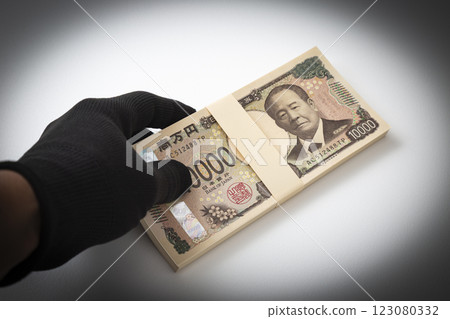 Hand holding a stack of 1 million yen bills Hand holding a stack of 1 million yen bills 123080332