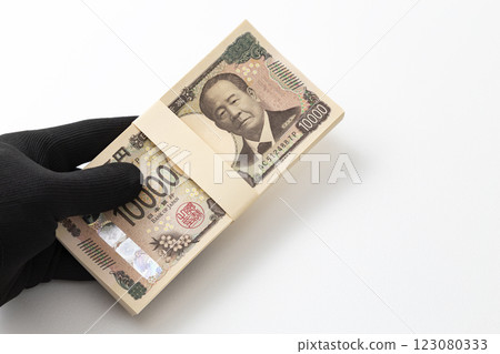 Hand holding a stack of 1 million yen bills 123080333