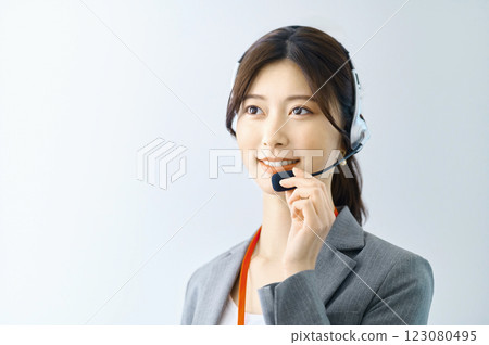 Female operator wearing an intercom Filming cooperation: SKY Perfect Tokyo Media Center Female operator wearing an intercom Filming cooperation: SKY Perfect Tokyo Media Center 123080495