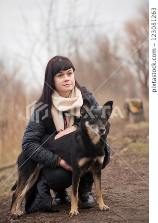 Portrait of a woman holding her dog in the park Portrait of a woman holding her dog in the park 123081263