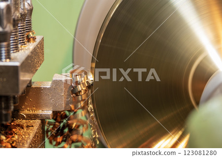 Closeup scene the lathe machine finish cut the brass parts by lathe tools. Closeup scene the lathe machine finish cut the brass parts by lathe tools. 123081280