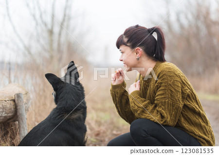 Happy woman with dog on the street 123081535