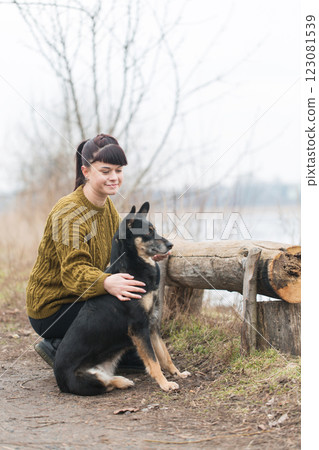 Woman walking her dog in a park 123081539