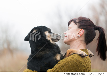 Woman and shepherd dog hugging on a walk Woman and shepherd dog hugging on a walk 123081544