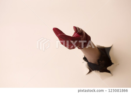 A woman's hand in a leather glove shows a gesture of request 123081866