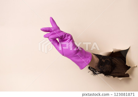 Beautiful female hand in a fuchsia leather glove 123081871