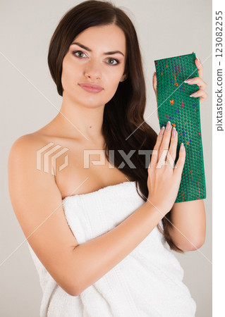 Beautiful woman with dark hair with a needle massager in her hands Beautiful woman with dark hair with a needle massager in her hands 123082255