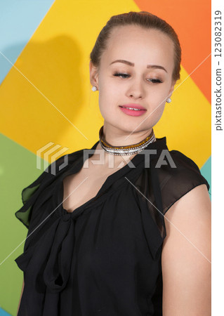 A woman wearing a dress and a necklace with shy look on face, close-up A woman wearing a dress and a necklace with shy look on face, close-up 123082319