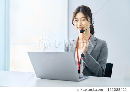 Female operator wearing an intercom Filming cooperation: SKY Perfect Tokyo Media Center Female operator wearing an intercom Filming cooperation: SKY Perfect Tokyo Media Center 123082411