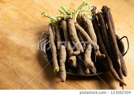 Two varieties of dietary healthy product scorzonera roots on a metal vintage tray Two varieties of dietary healthy product scorzonera roots on a metal vintage tray 123082504
