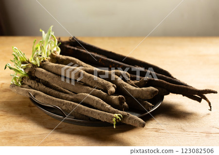 Two varieties of dietary healthy product scorzonera roots on a metal vintage tray Two varieties of dietary healthy product scorzonera roots on a metal vintage tray 123082506