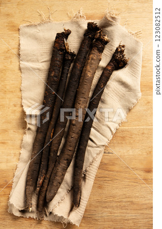 Dietary medicinal earth vegetable scorzonera on a linen napkin, top view 123082512