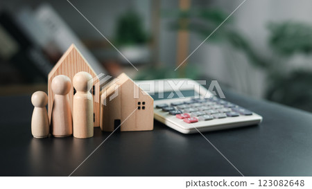 House model and the human next to the calculator emphasize real estate and financial planning, Clearly representing banking, Saving and investing for the security of future assets, property,finance. House model and the human next to the calculator emphasize real estate and financial planning, Clearly representing banking, Saving and investing for the security of future assets, property,finance. 123082648