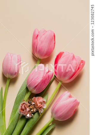 Spring still life handmade beetle brooch with pink bottom tulips, top view Spring still life handmade beetle brooch with pink bottom tulips, top view 123082745
