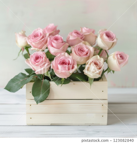 Pink Roses in Wooden Box Against Soft Pastel Background 123082840