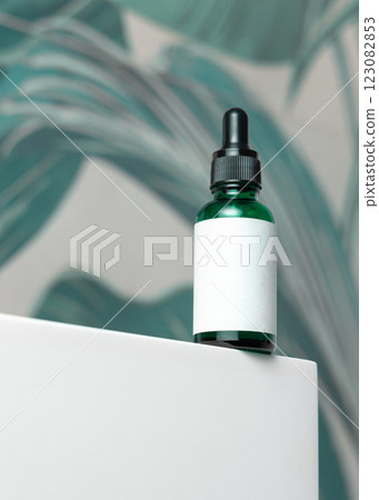 Green glass dropper bottle with pipette on washbasin in green bathroom close up cosmetic mockup Green glass dropper bottle with pipette on washbasin in green bathroom close up cosmetic mockup 123082853