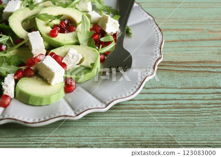 Healthy fitness salad with pomegranate, arugula, avocado, feta . Vegetarian nutritious salad. Keto diet. Keto lunch idea recipe 123083000