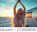 Beautiful caucasian blonde woman enjoying sunset in front of camper trailer 123084094