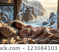 Young woman sleeping in camper van enjoying stunning winter ocean view 123084103