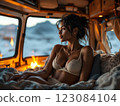 Beautiful woman relaxing in camper van looking out window at sunset 123084104