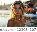 Blonde model bathing in a frozen lake with a Mercedes Sprinter 4x4 van in the background 123084107